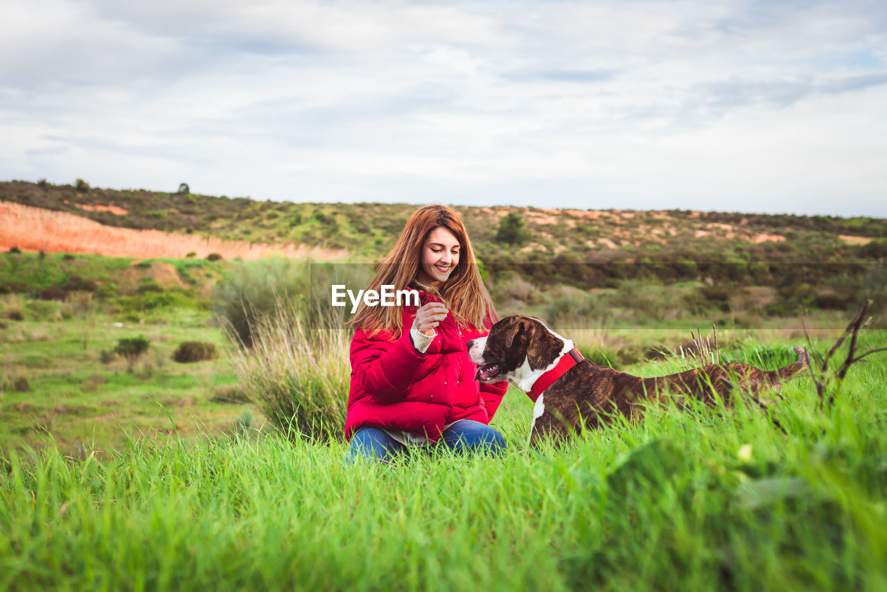 Woman with dog on grass