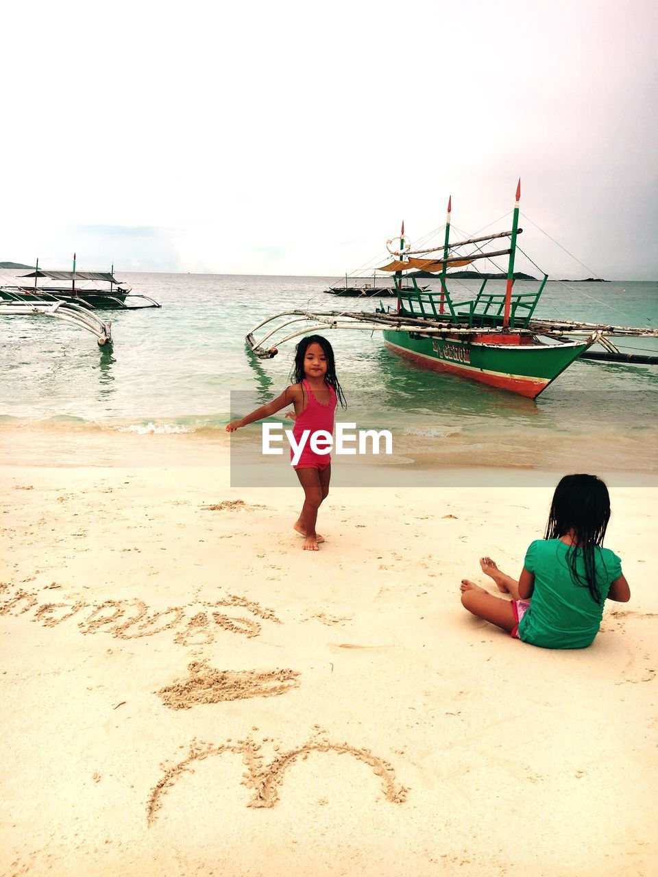 WOMAN STANDING ON BEACH