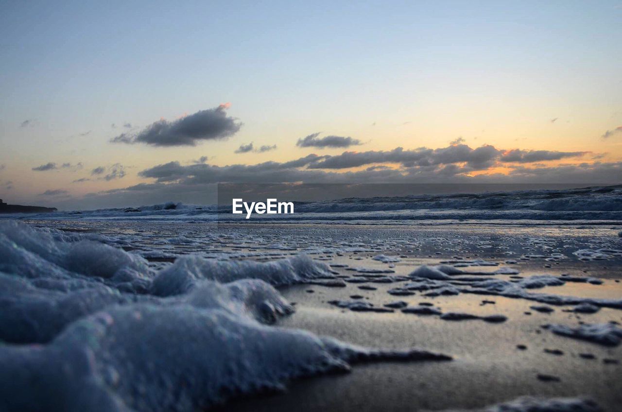 Scenic view of beach against sky during sunset