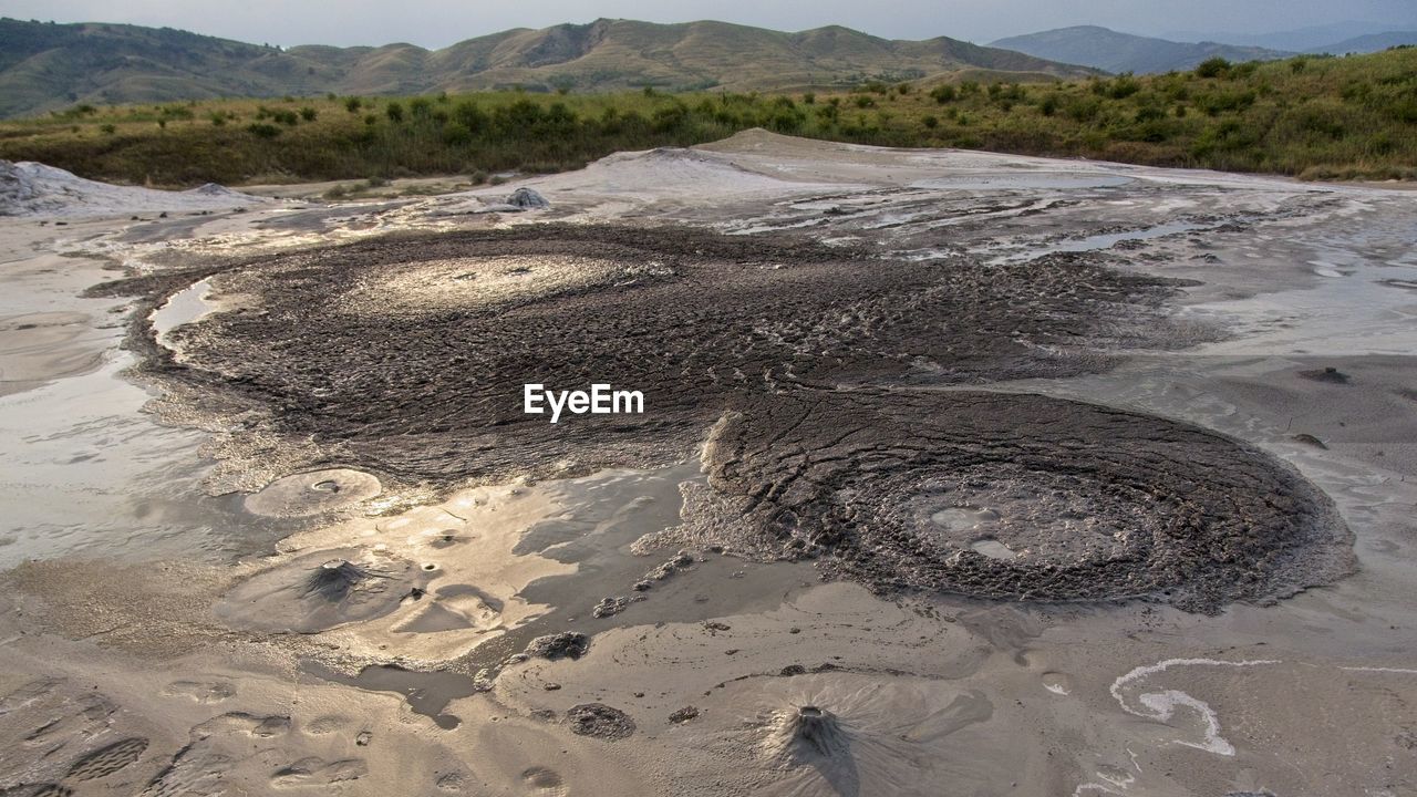 HIGH ANGLE VIEW OF WET SAND ON SHORE