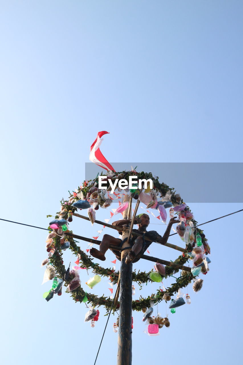 LOW ANGLE VIEW OF ILLUMINATED FERRIS WHEEL AGAINST CLEAR SKY