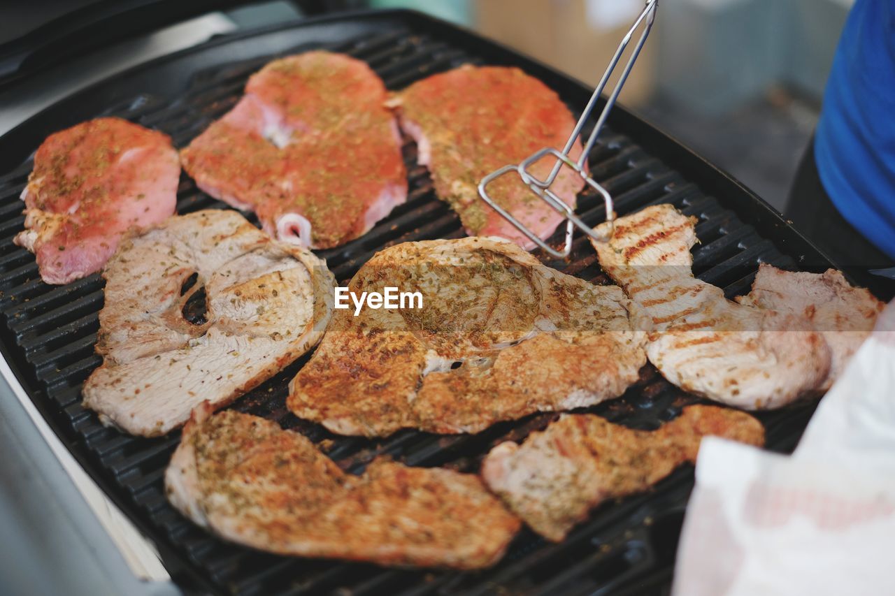 High angle view of meat cooking in barbecue grill
