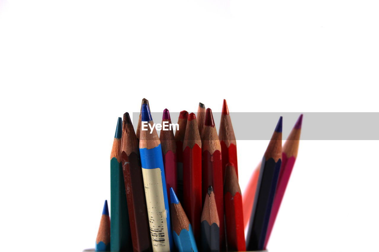 Close-up of colored pencils against white background