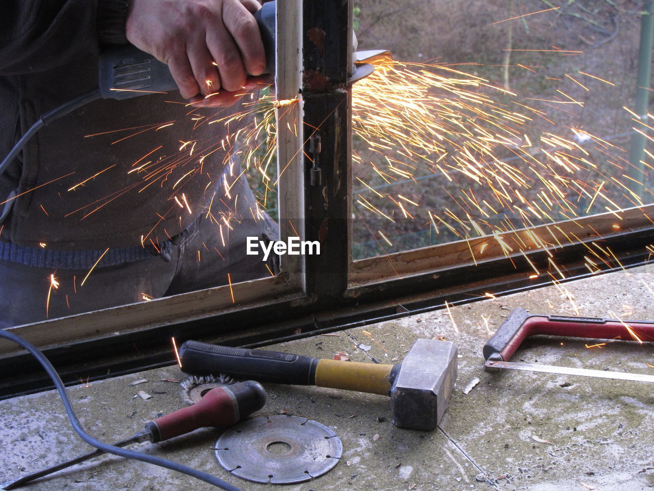 CLOSE-UP OF MAN WORKING ON FACTORY