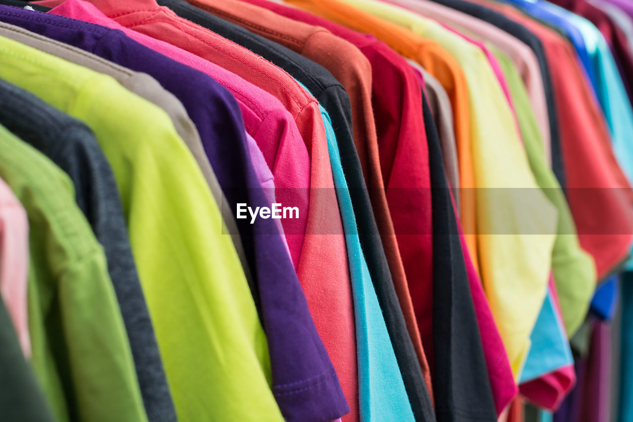 Full frame shot of colorful shirts hanging on coathangers