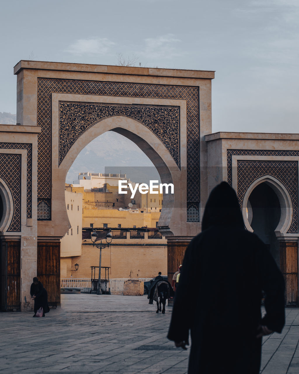 architecture, arch, built structure, travel destinations, religion, place of worship, landmark, tourism, city, history, the past, travel, building exterior, adult, ancient history, sky, rear view, nature, lifestyles, outdoors, men, group of people, triumphal arch, tourist