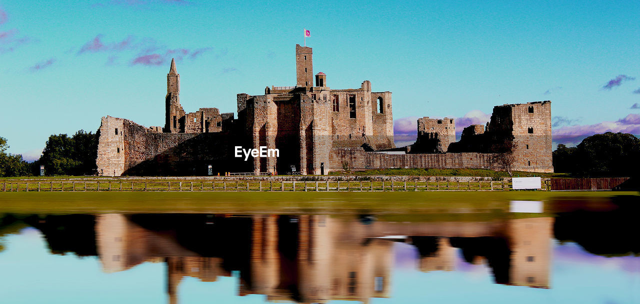 REFLECTION OF BUILDING IN LAKE