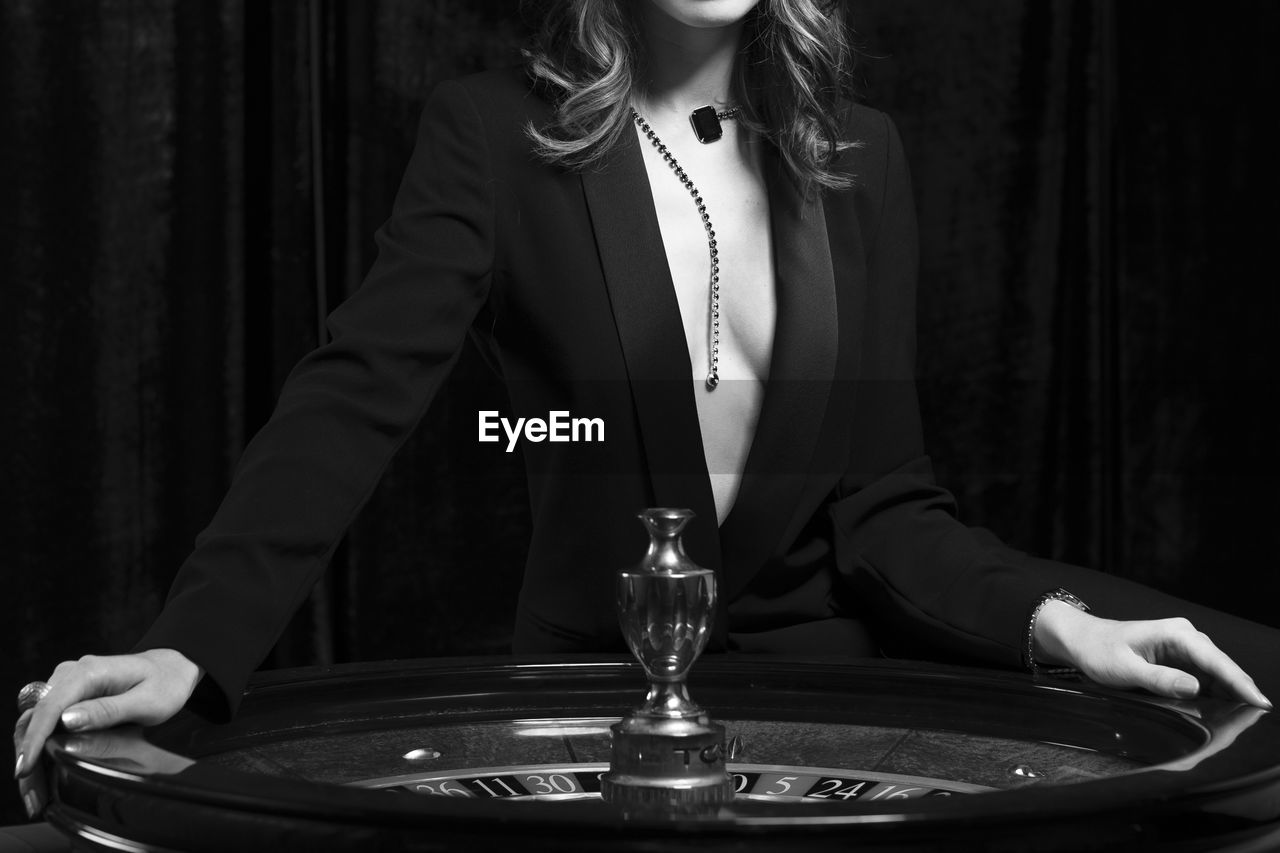 Midsection of woman at roulette wheel