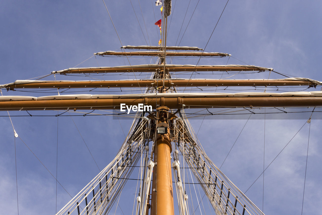 Low angle view of chain swing ride against sky