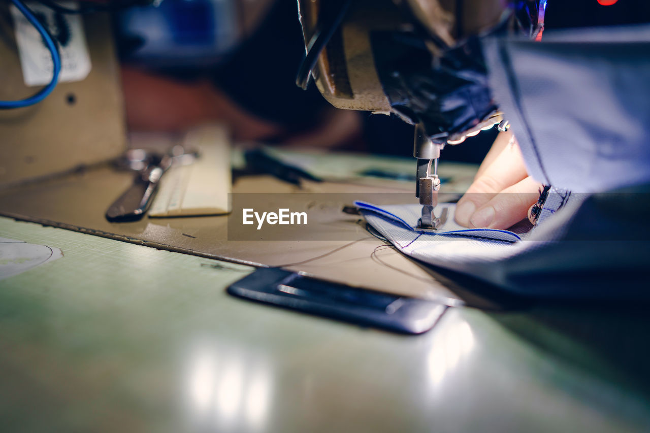 High angle view of man working on sewing machine