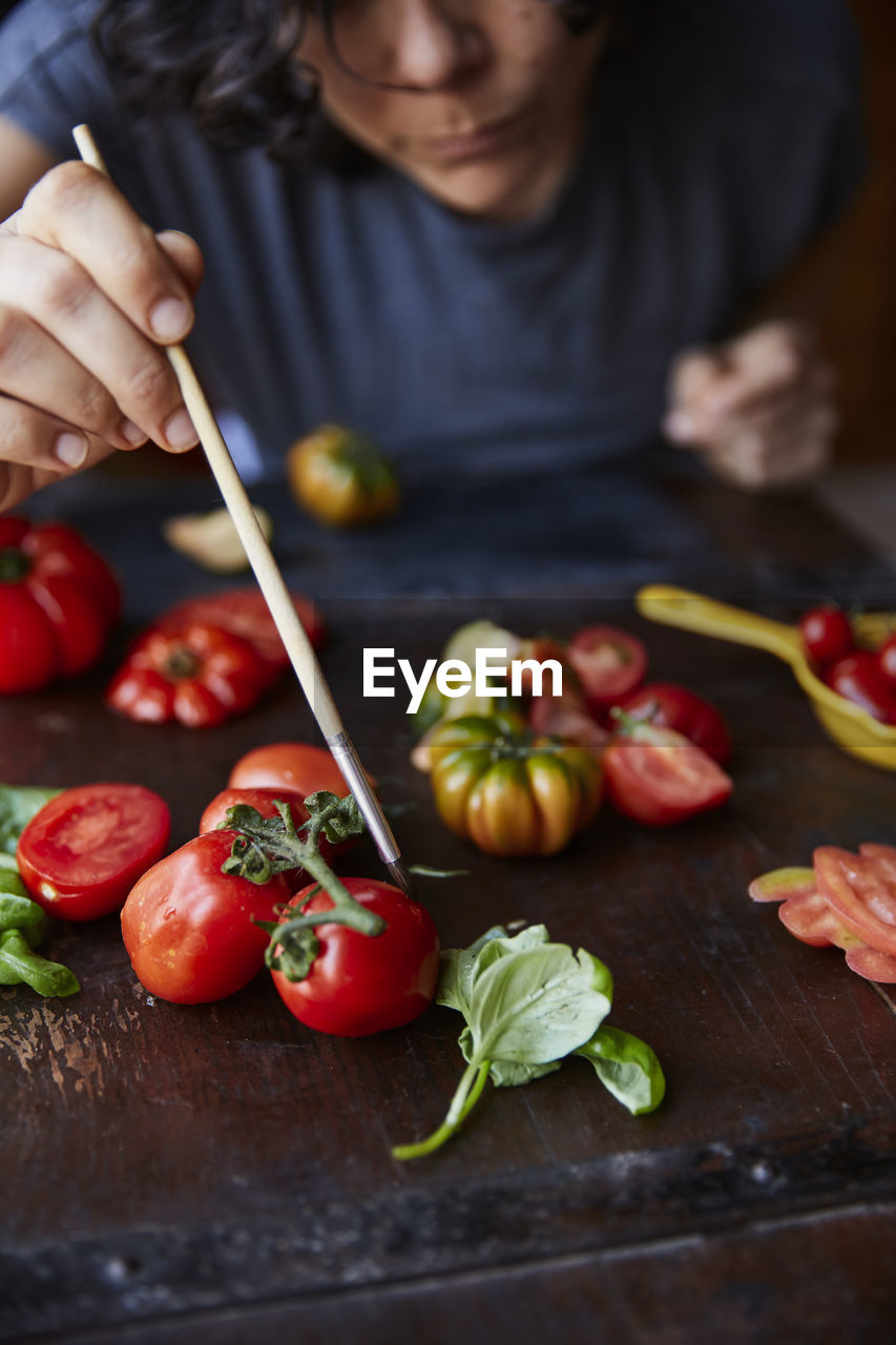 Woman arranging tomatoes for photo