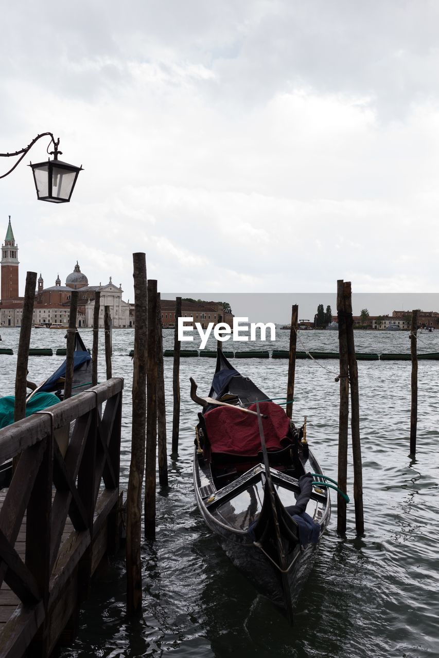 Boats moored in sea against sky