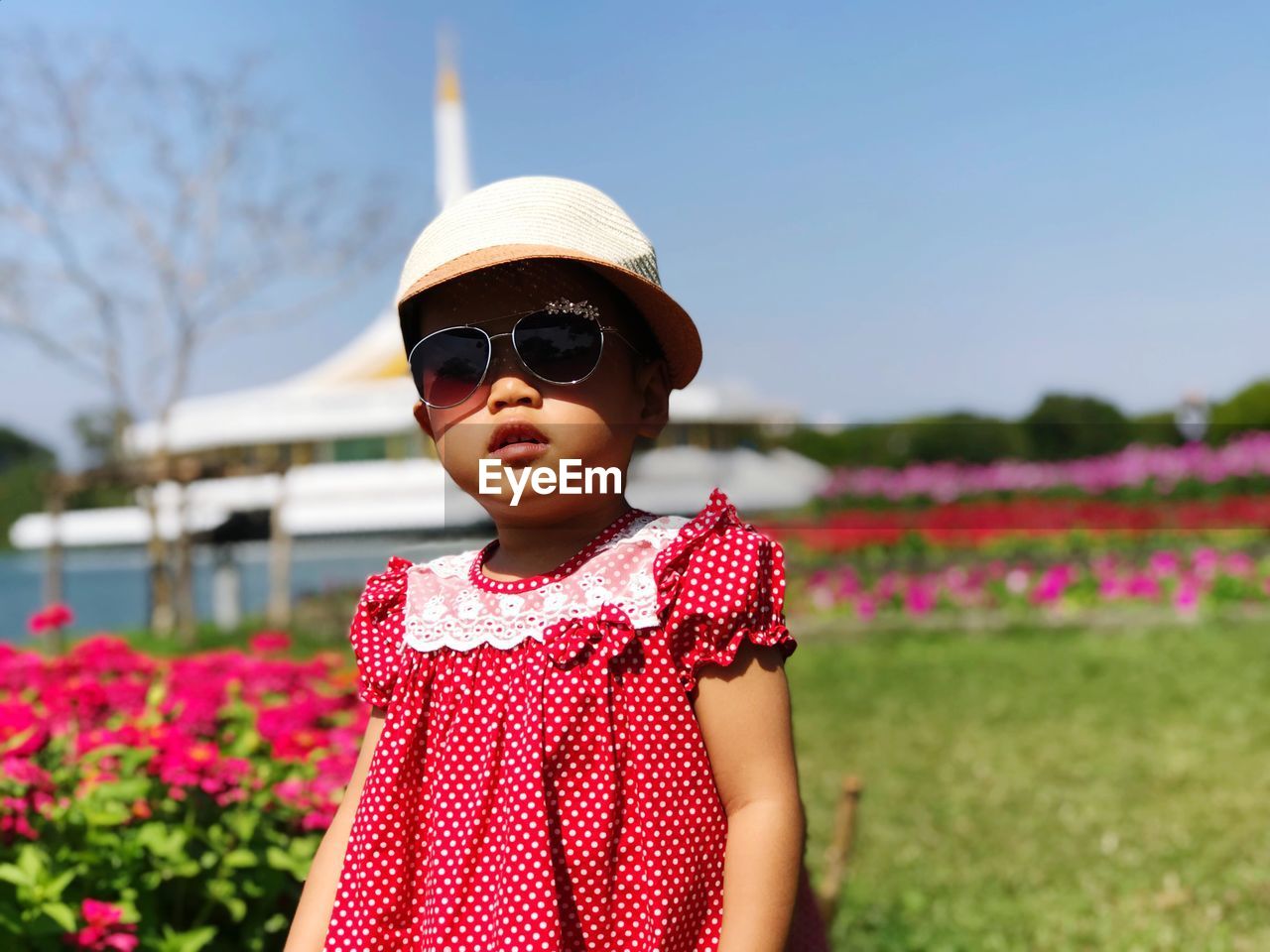 Girl wearing sunglasses while standing on field