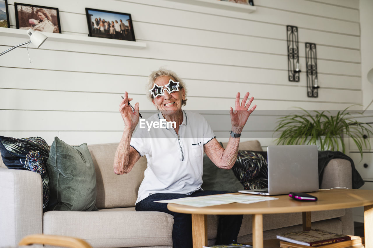Happy woman wearing star-shaped sunglasses