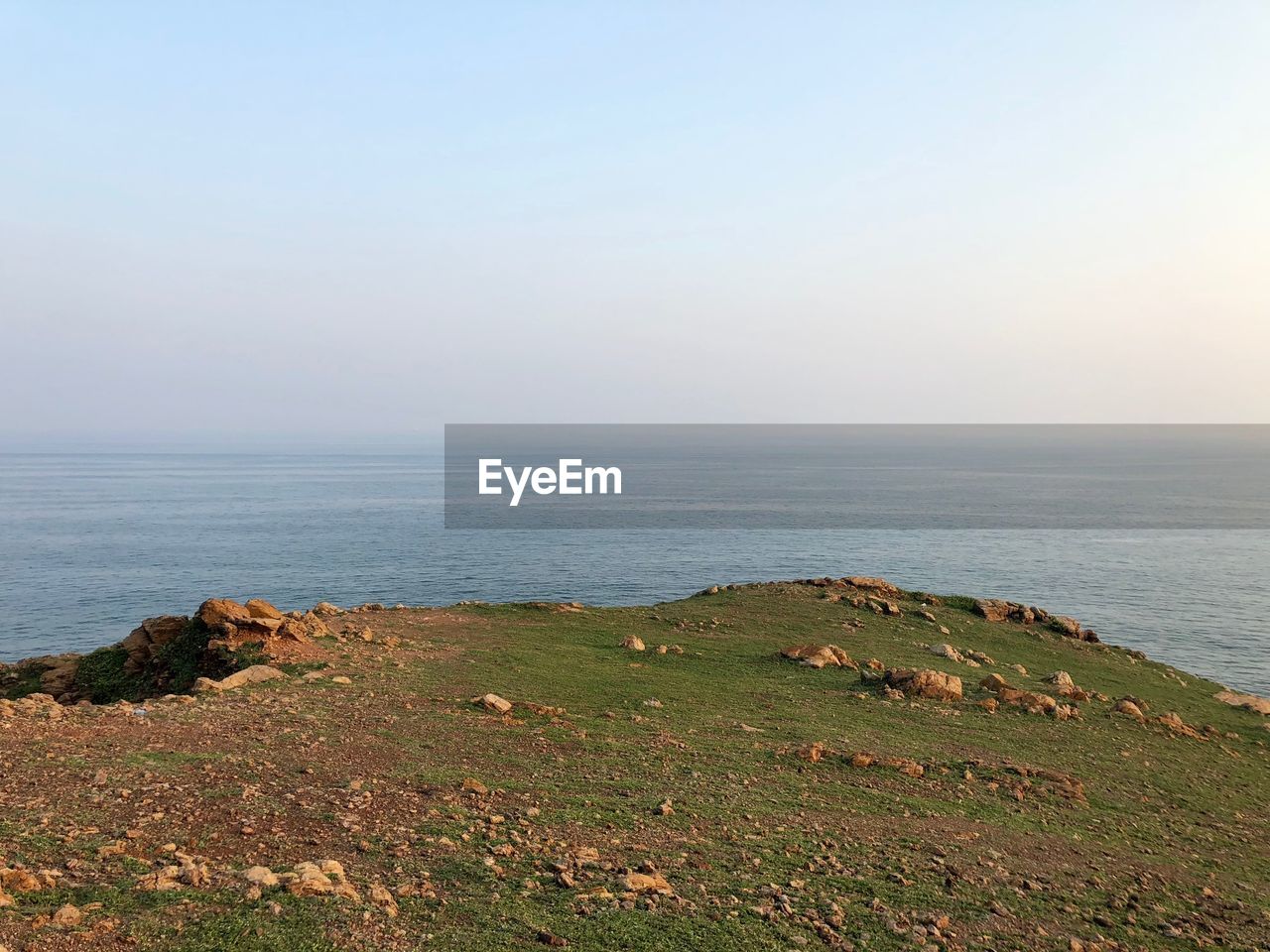 SCENIC VIEW OF SEA SHORE AGAINST SKY