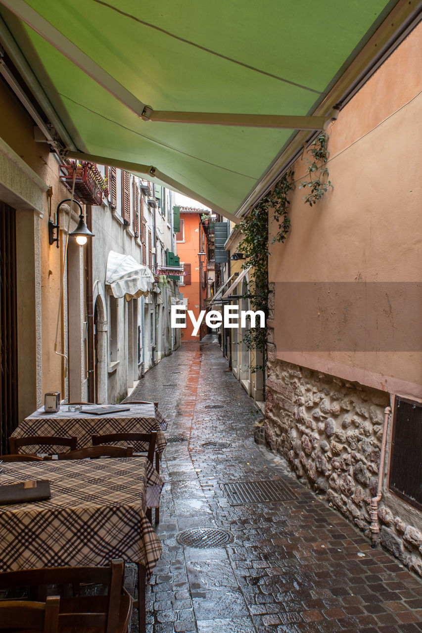 EMPTY ALLEY AMIDST BUILDINGS