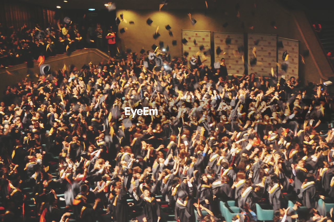 High angle view of graduates throwing mortarboards