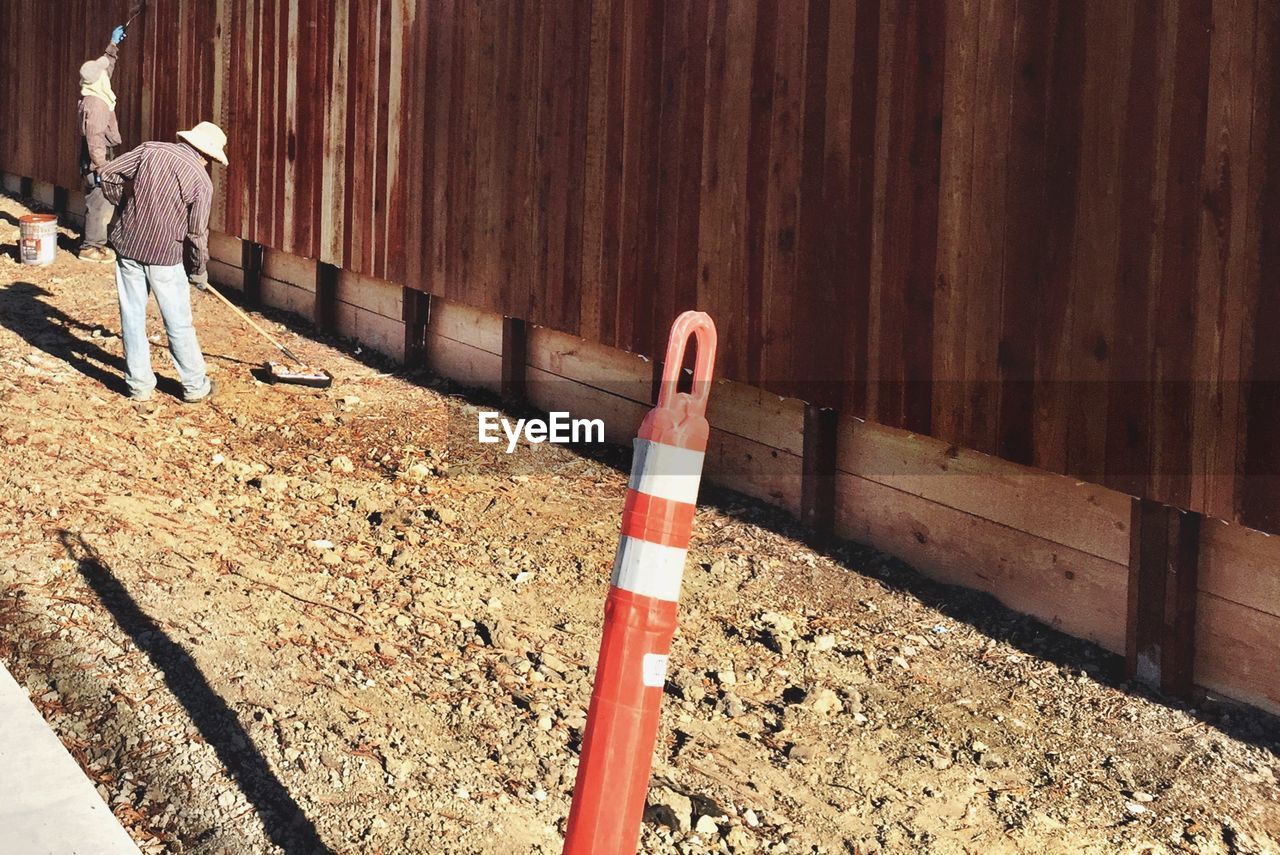 Man working by fence