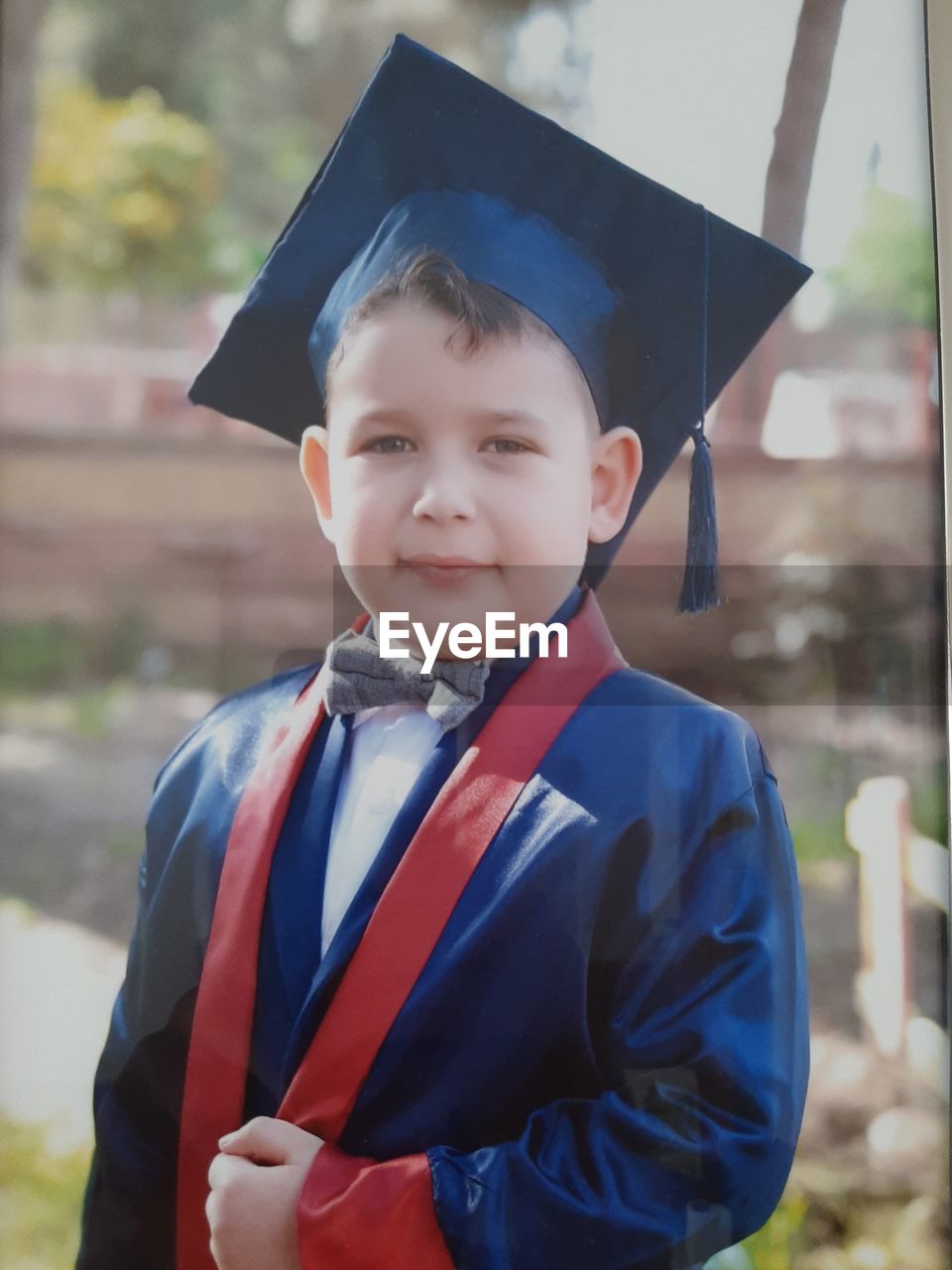 Portrait of smiling boy graduation gown