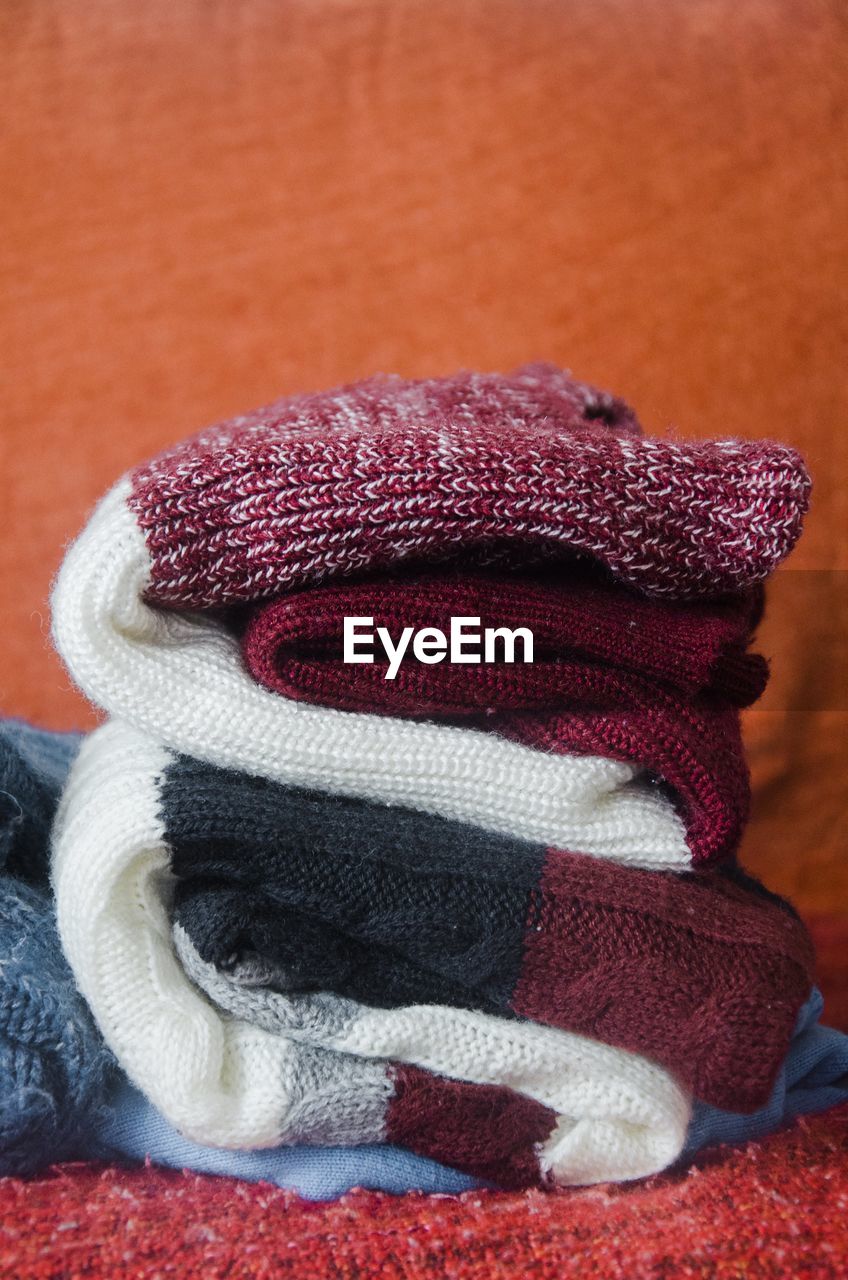 Close-up of sweaters folded on table