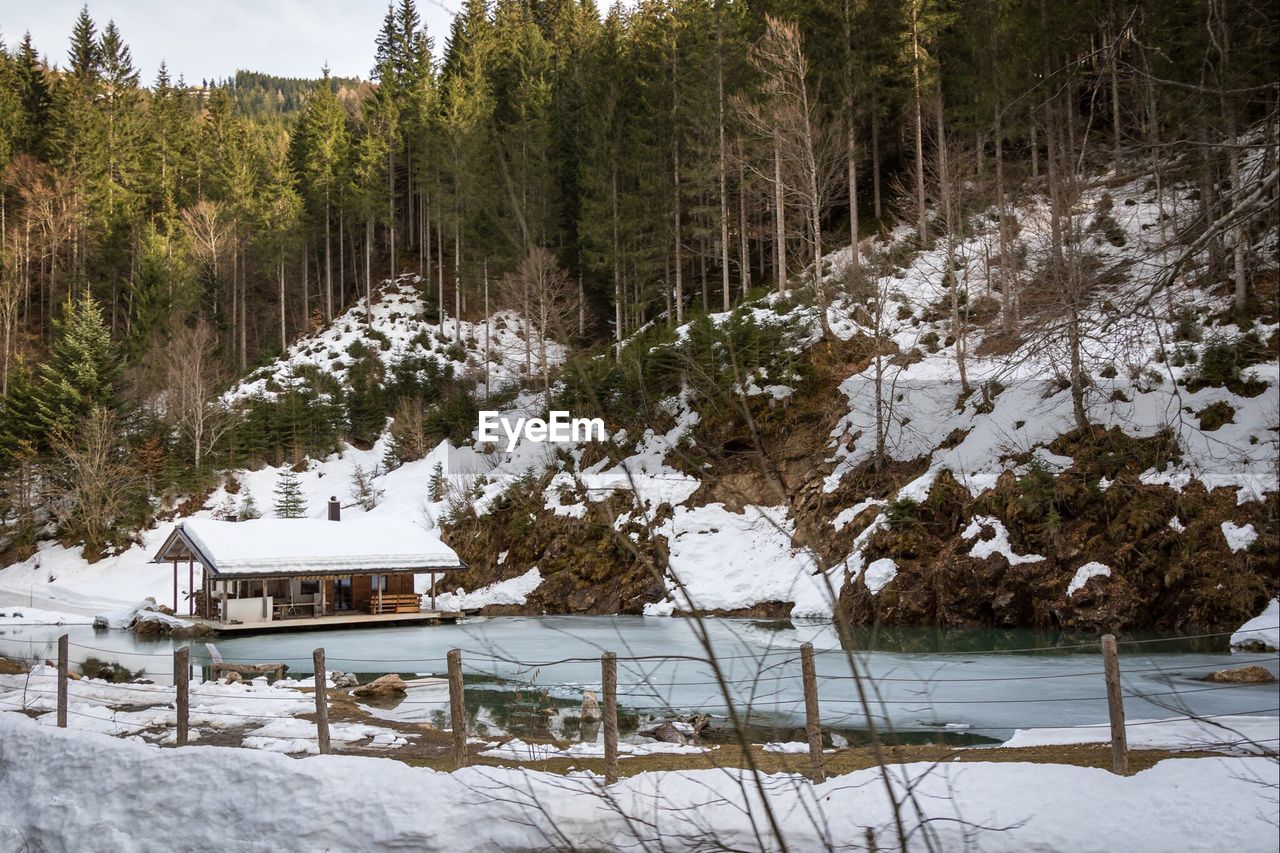 Calm lake along snowed landscape