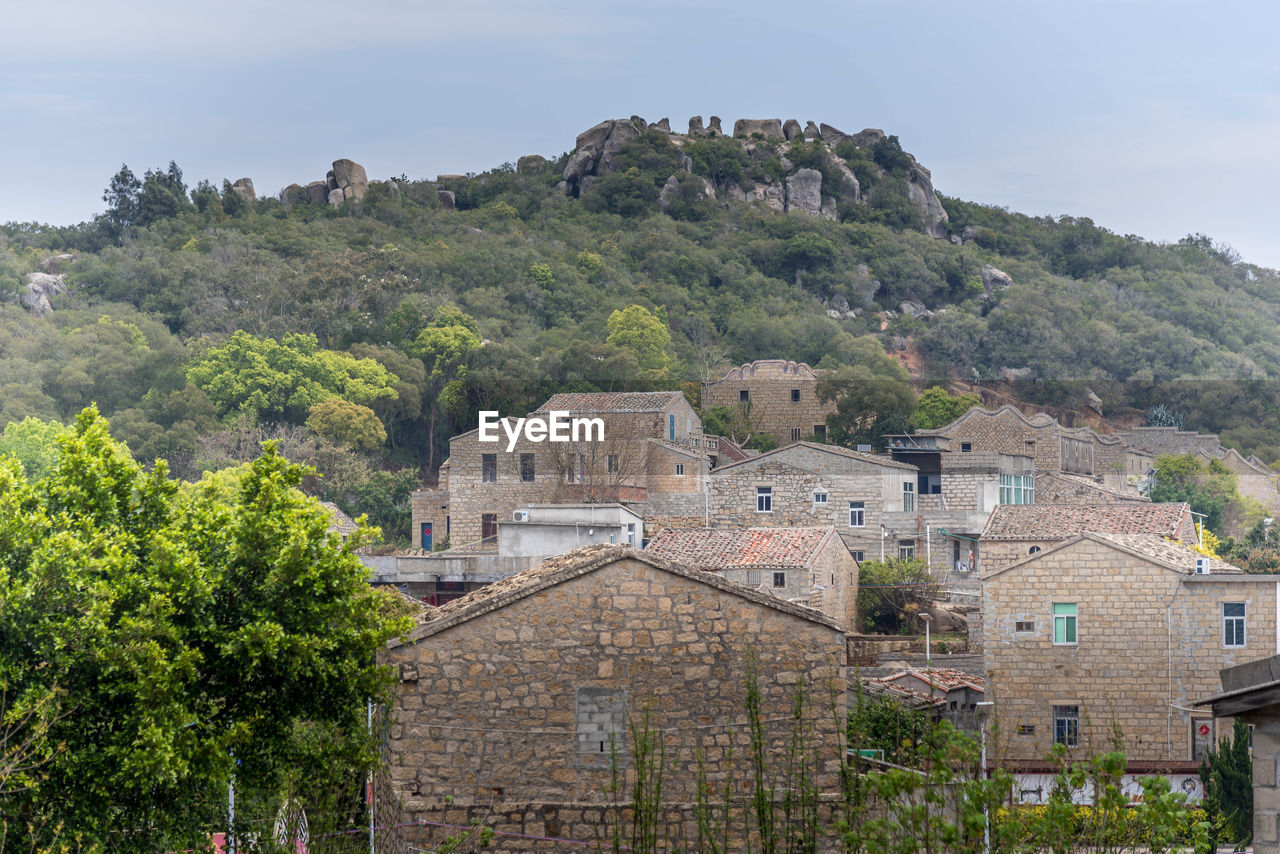 architecture, building exterior, built structure, building, town, plant, village, tree, nature, city, land, house, residential district, travel destinations, sky, travel, history, tourism, the past, landscape, no people, mountain, environment, outdoors, rural area, estate, vacation, old, scenics - nature, street, fortification, rural scene, château, tradition, ancient, day, water, beauty in nature, cityscape