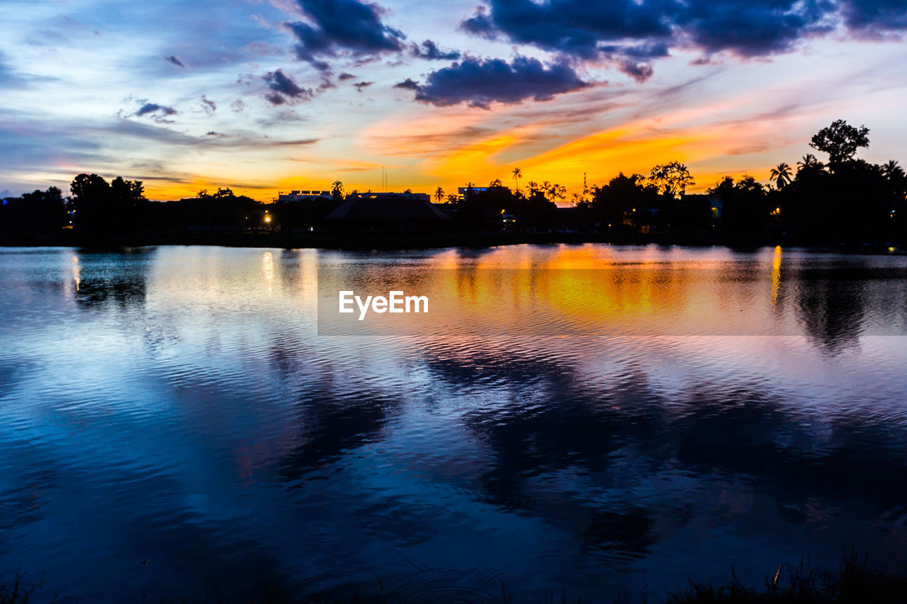 SILHOUETTE TREES BY LAKE AGAINST SKY DURING SUNSET