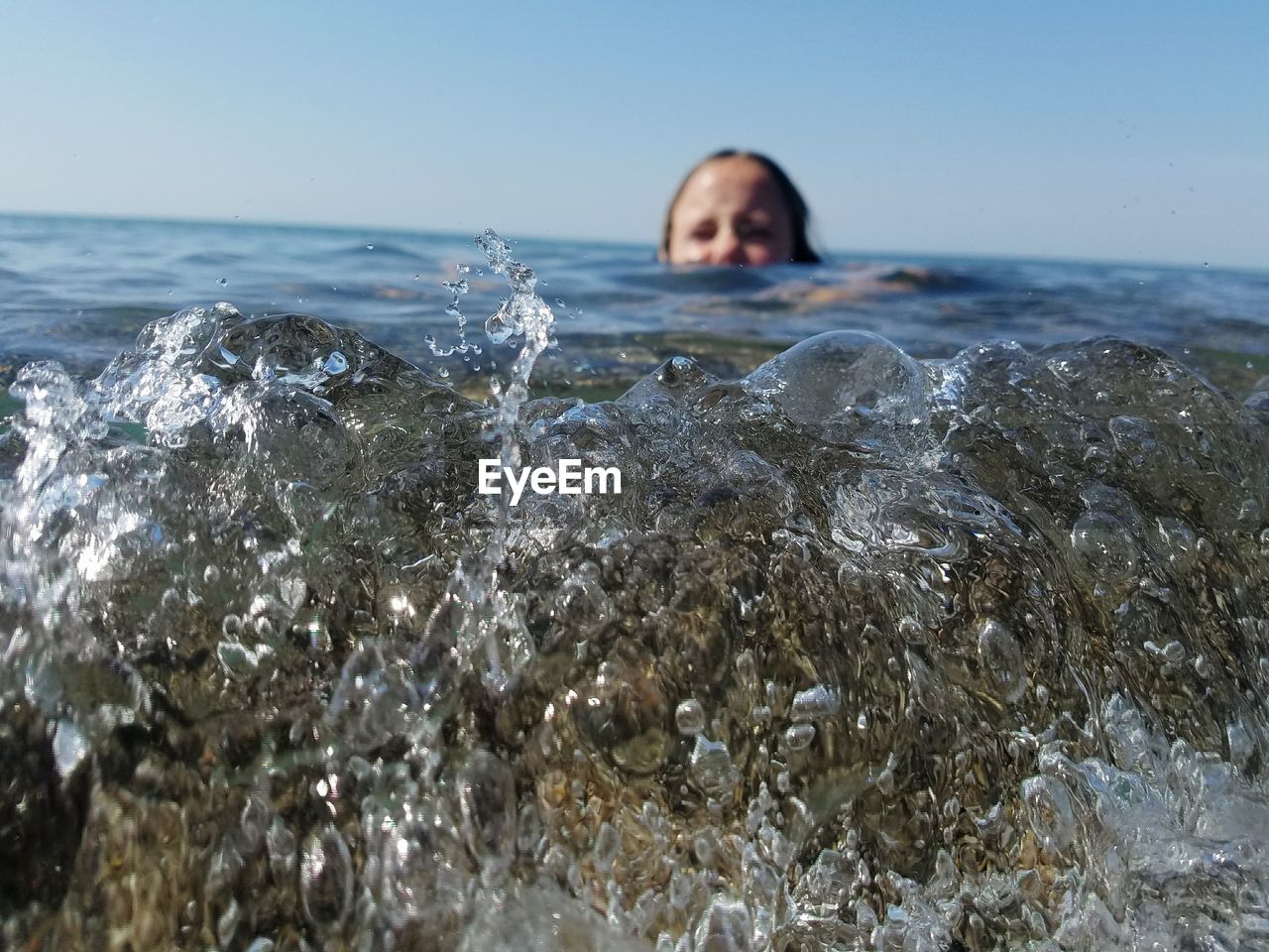 Surface level of girl swimming in sea