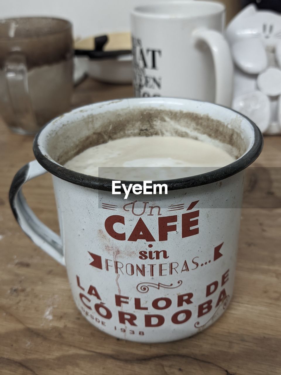 food and drink, cup, mug, drink, text, coffee cup, refreshment, indoors, coffee, table, western script, still life, no people, food, hot drink, drinkware, focus on foreground, ceramic, wood, close-up, communication, freshness