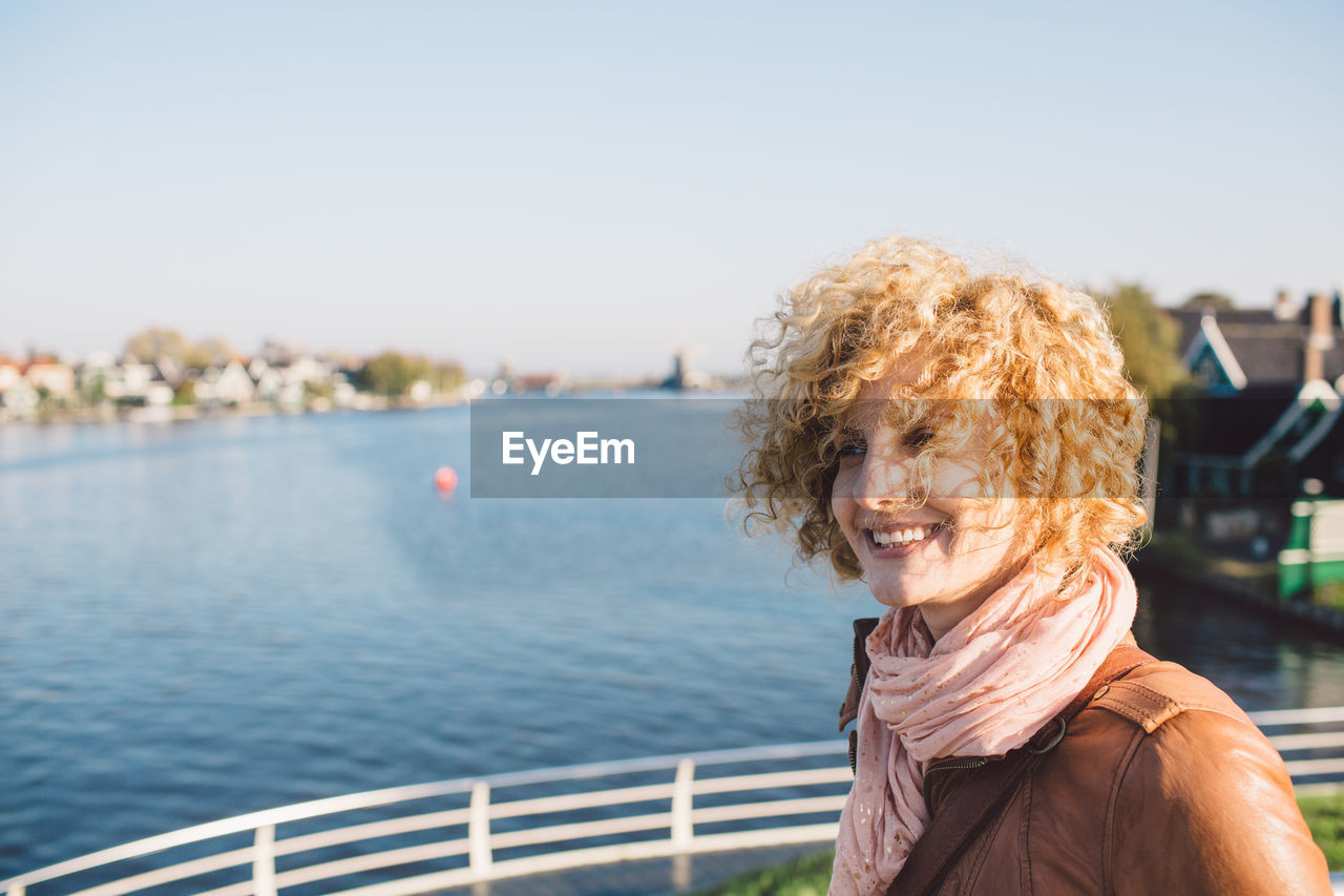 Smiling woman against river