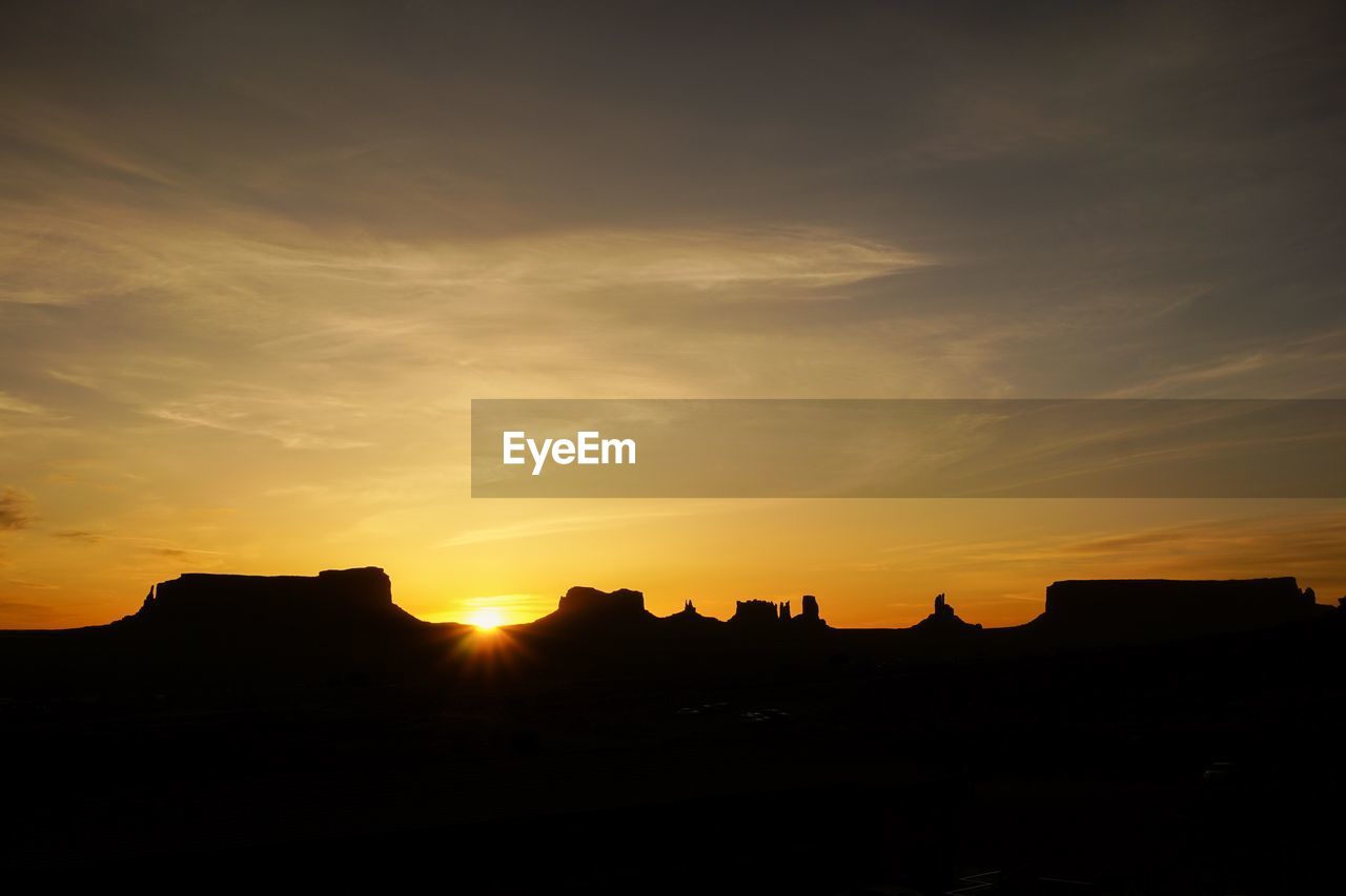 SILHOUETTE BUILDING AGAINST SKY DURING SUNSET