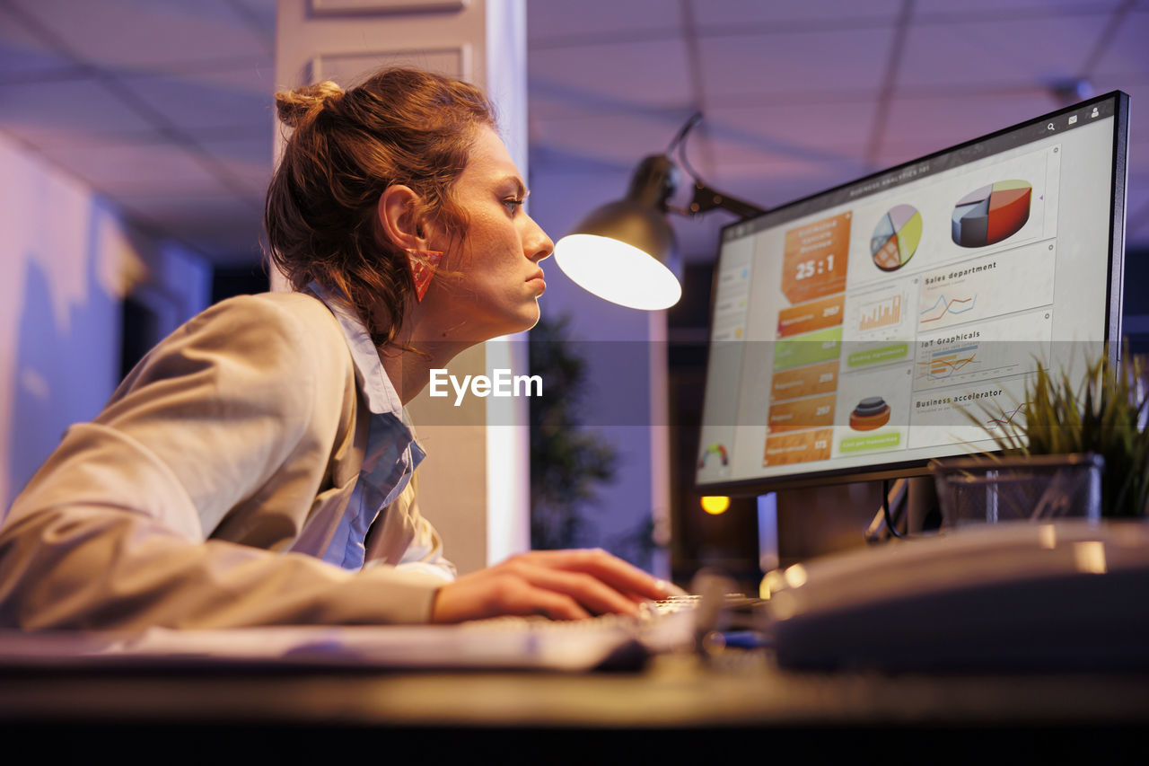 young woman using laptop on table in office