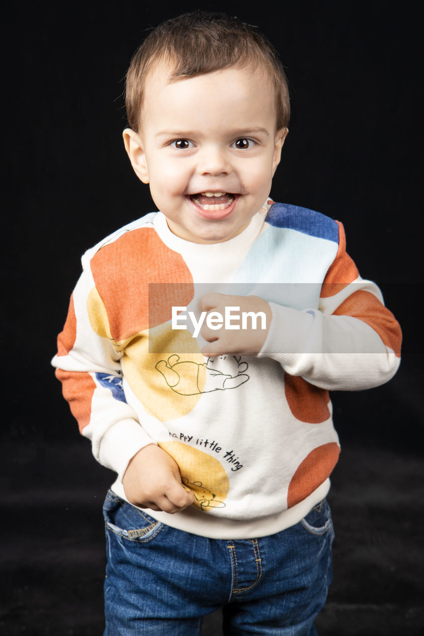 PORTRAIT OF CUTE BOY HOLDING BABY