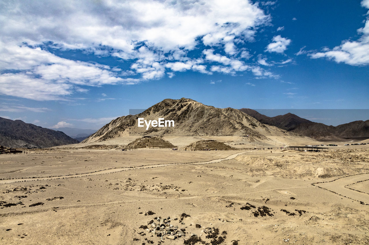 Scenic view of arid landscape against sky in caral 