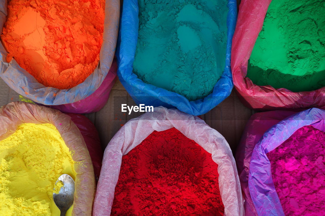 Directly above shot of color powder in sacks