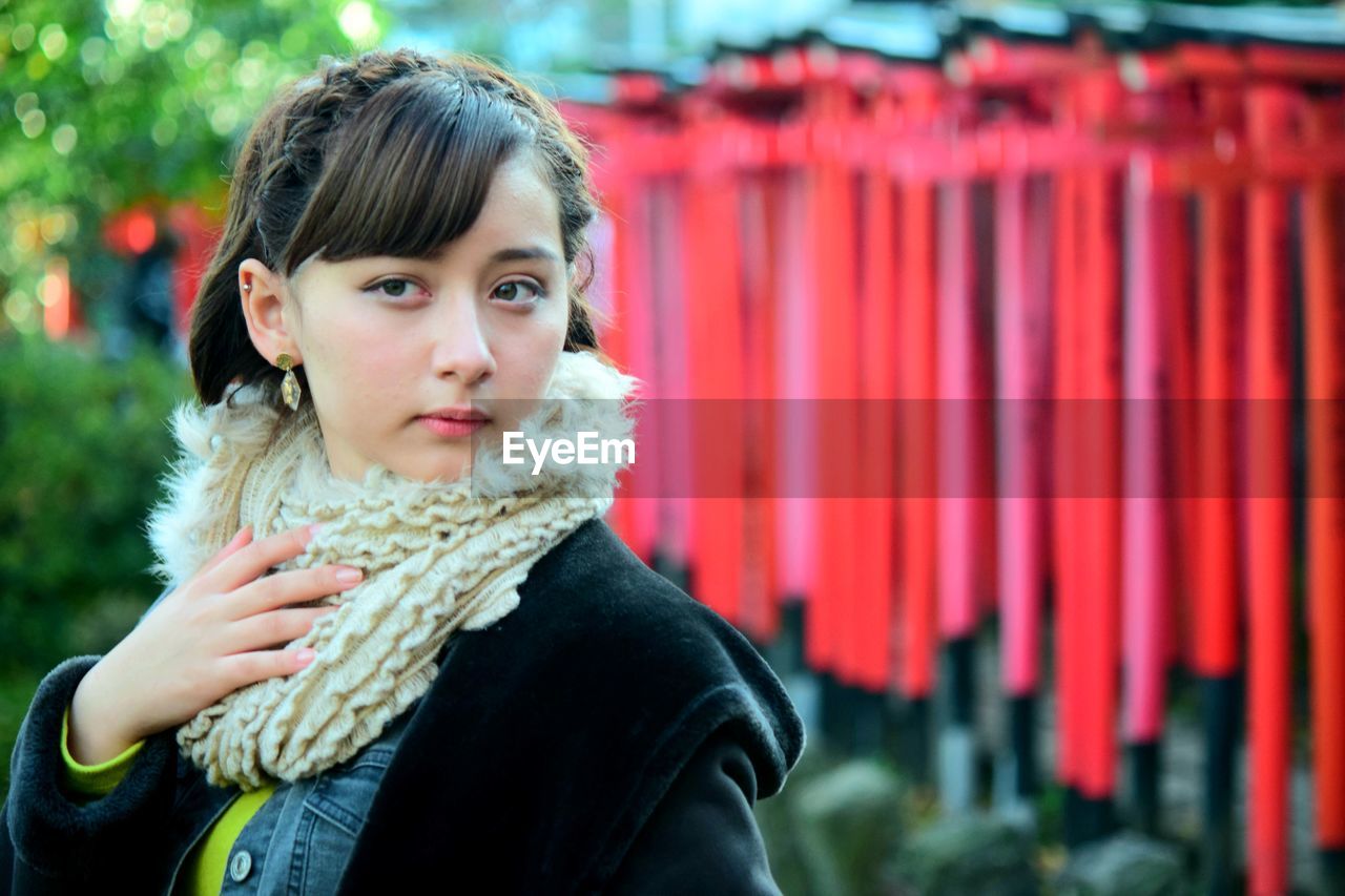 Portrait of young woman standing outdoors