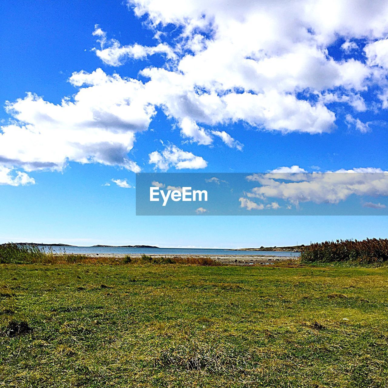 SCENIC VIEW OF CALM SEA AGAINST CLOUDY SKY