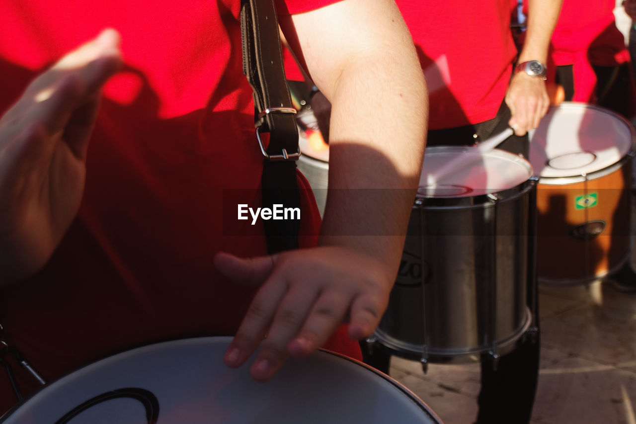 Midsection of drummer performing on street