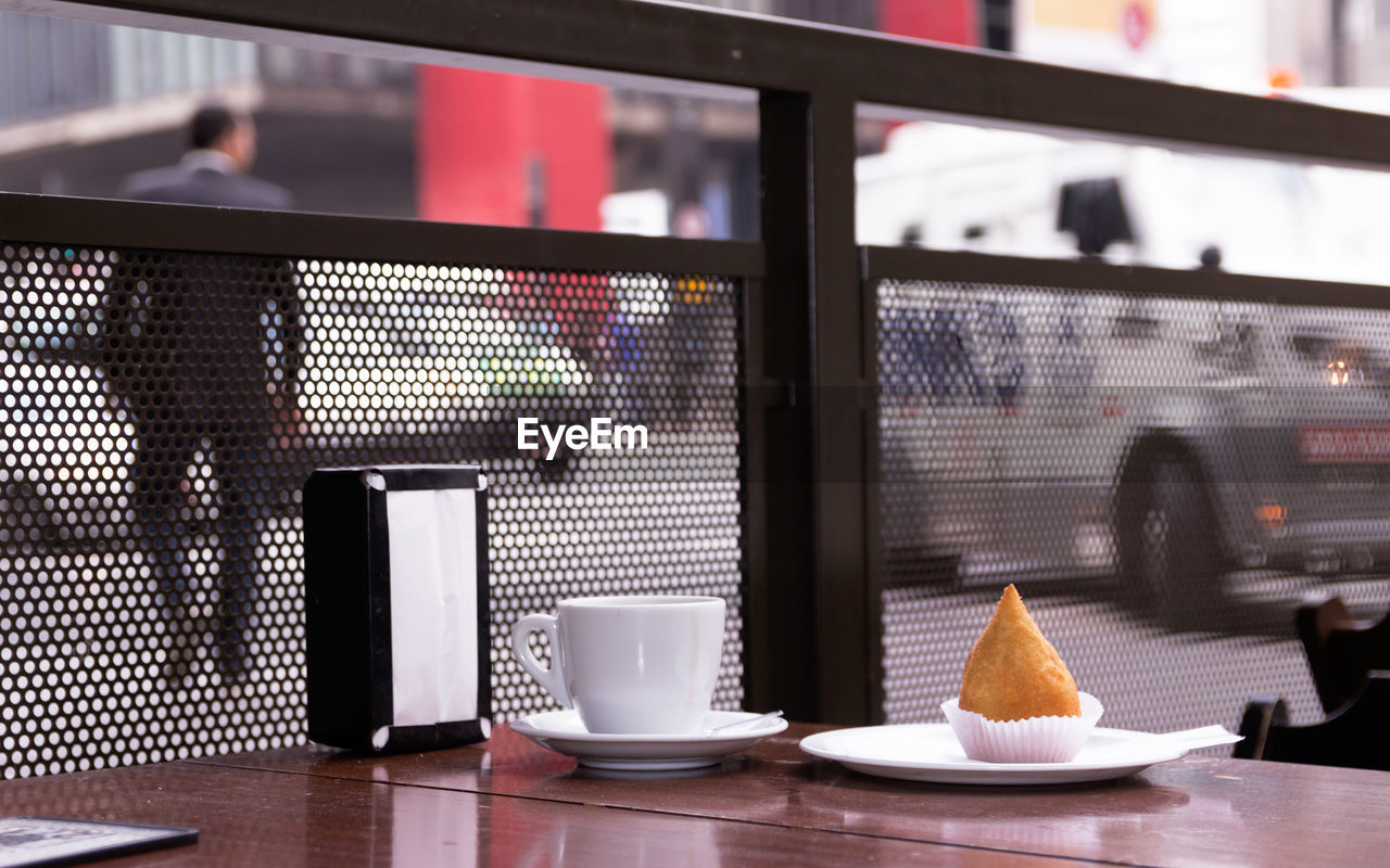 CLOSE-UP OF COFFEE SERVED ON TABLE IN CAFE