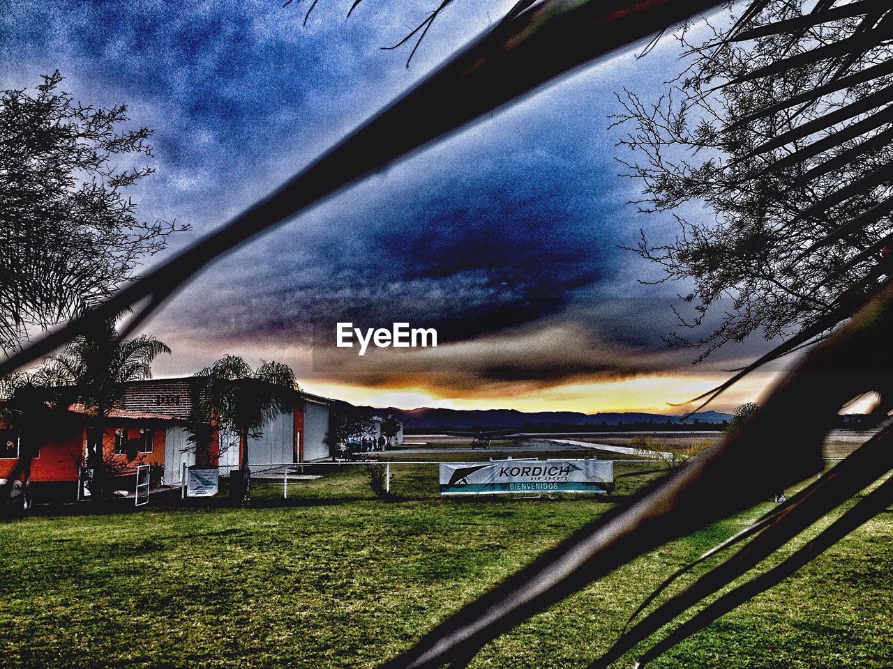 VIEW OF FIELD AGAINST CLOUDY SKY