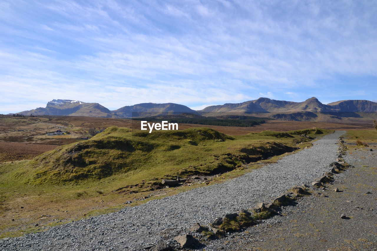 Scenic view of mountains against cloudy sky