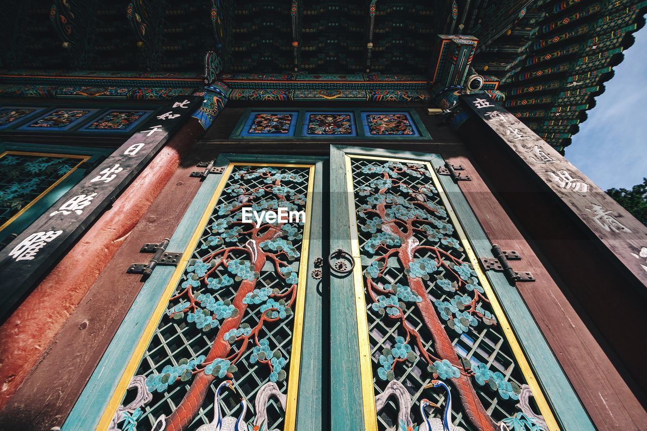 Low angle view of patterned door of buddhist temple