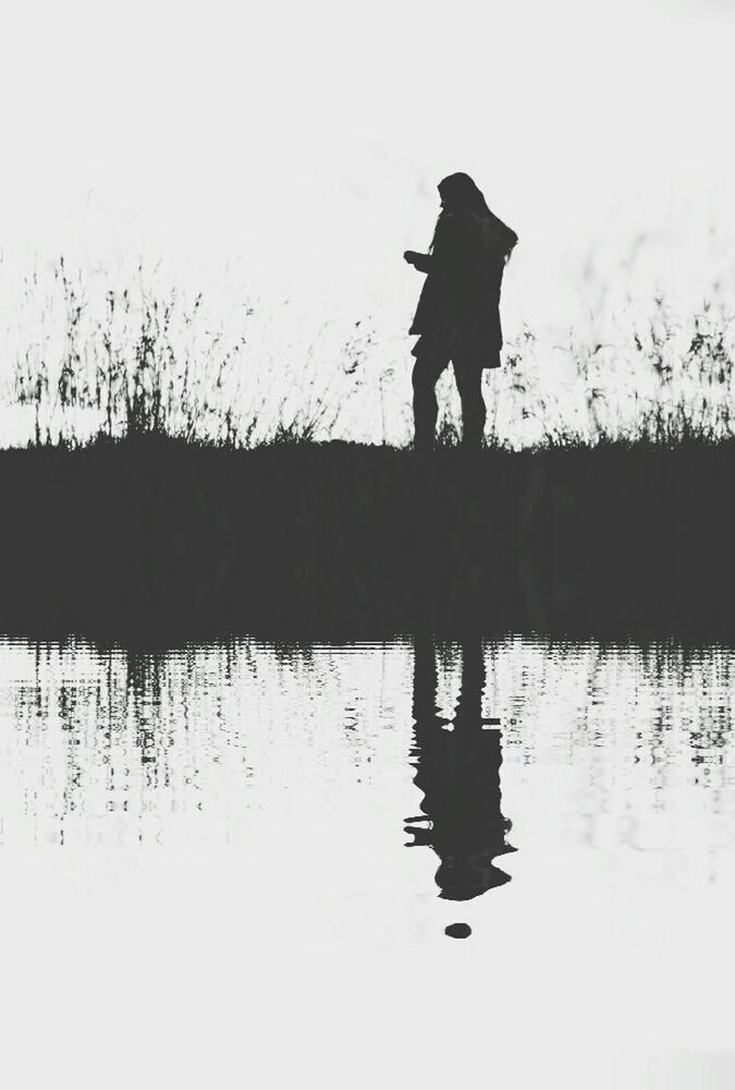 REFLECTION OF WOMAN IN WATER