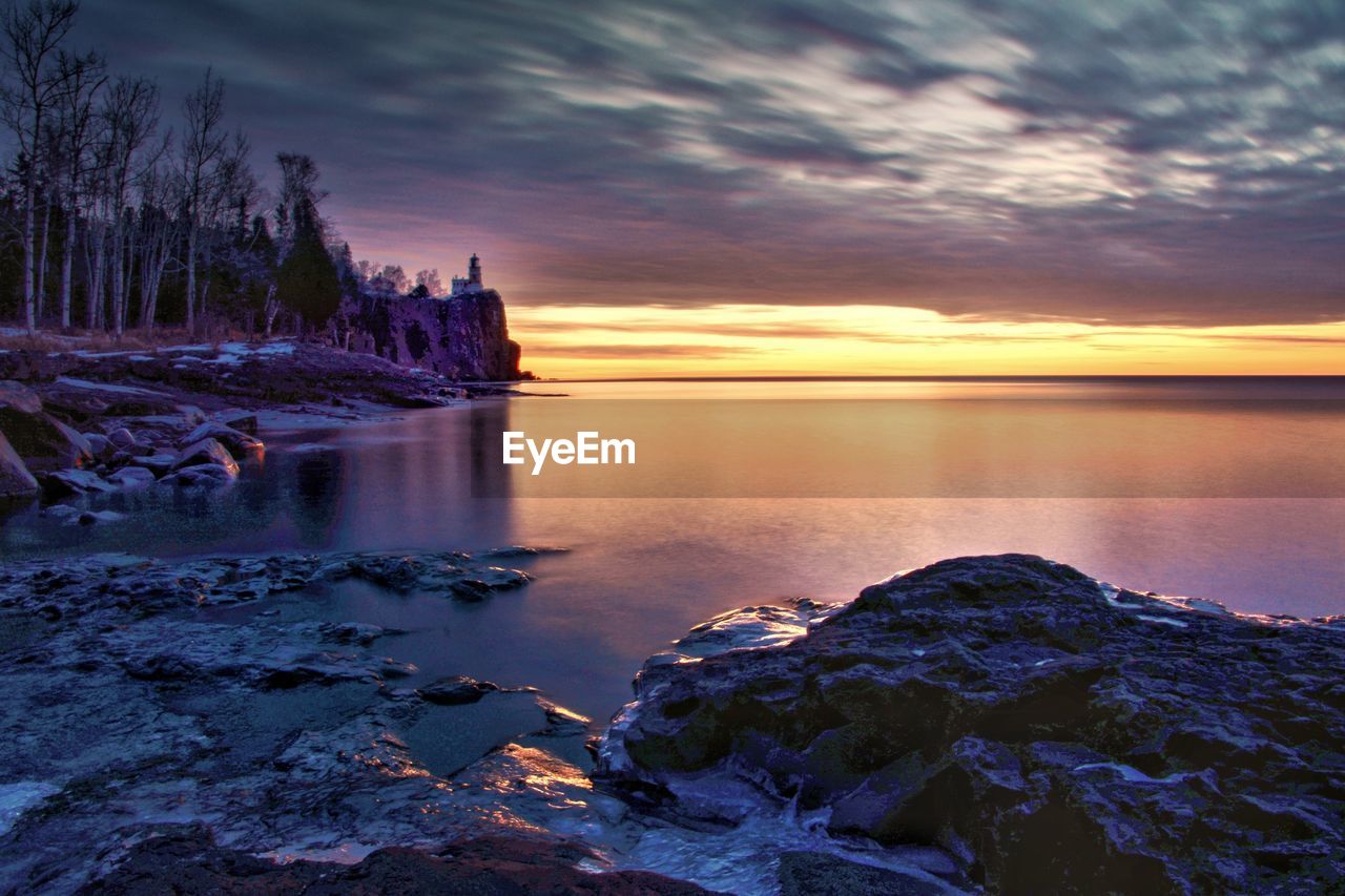 Scenic view of lake against sky during sunset