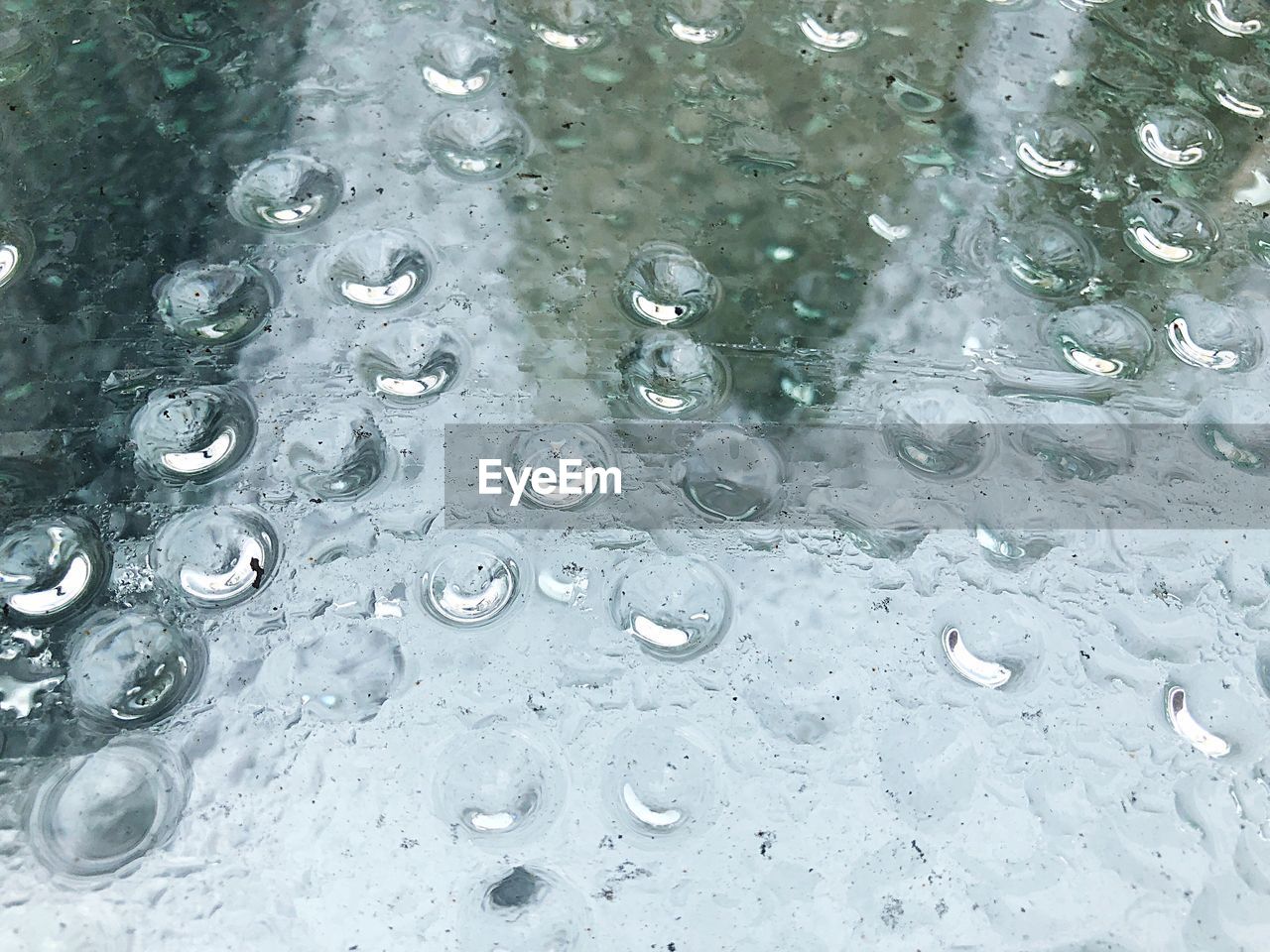 FULL FRAME SHOT OF WATER DROPS ON GLASS