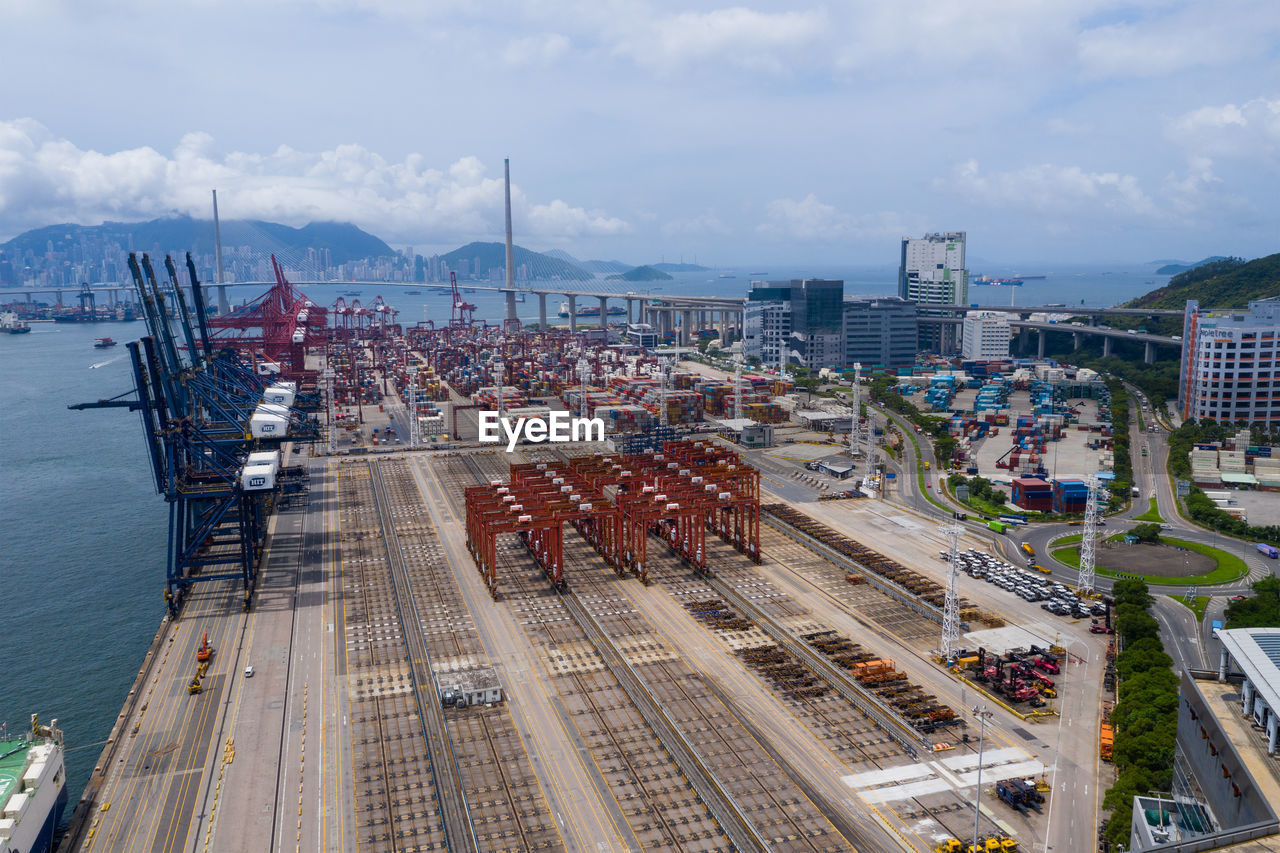 HIGH ANGLE VIEW OF COMMERCIAL DOCK AGAINST SKY