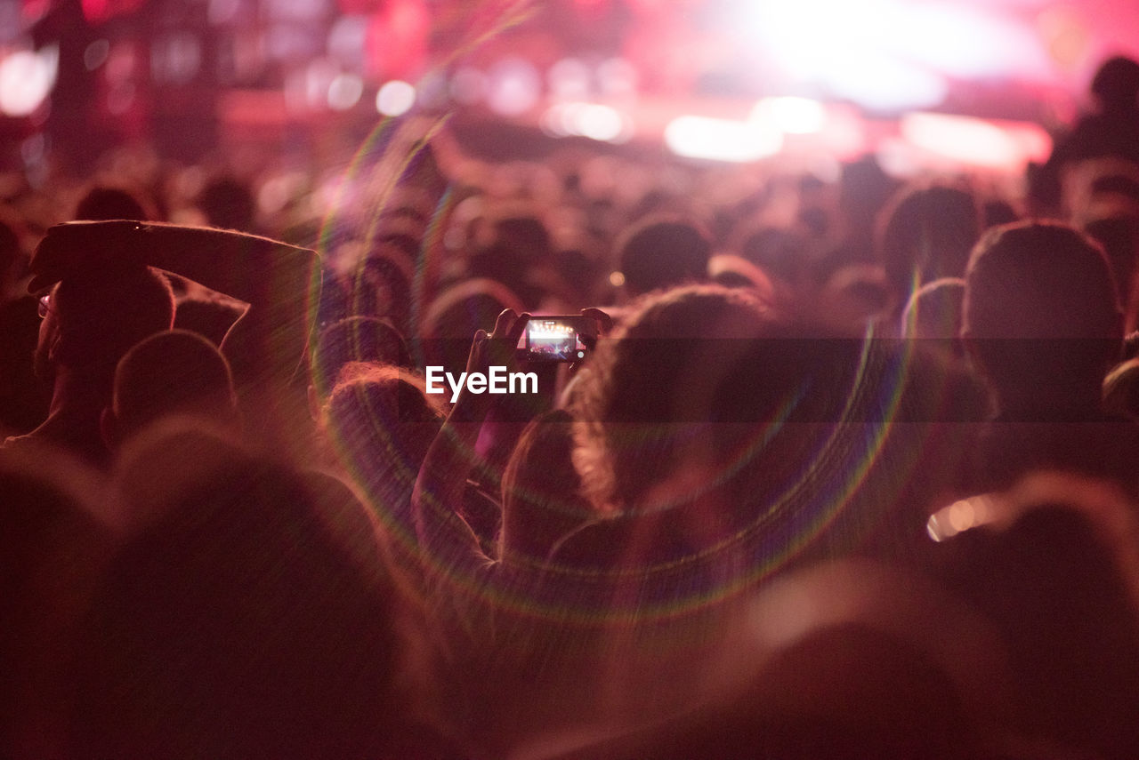 CROWD PHOTOGRAPHING AT NIGHT