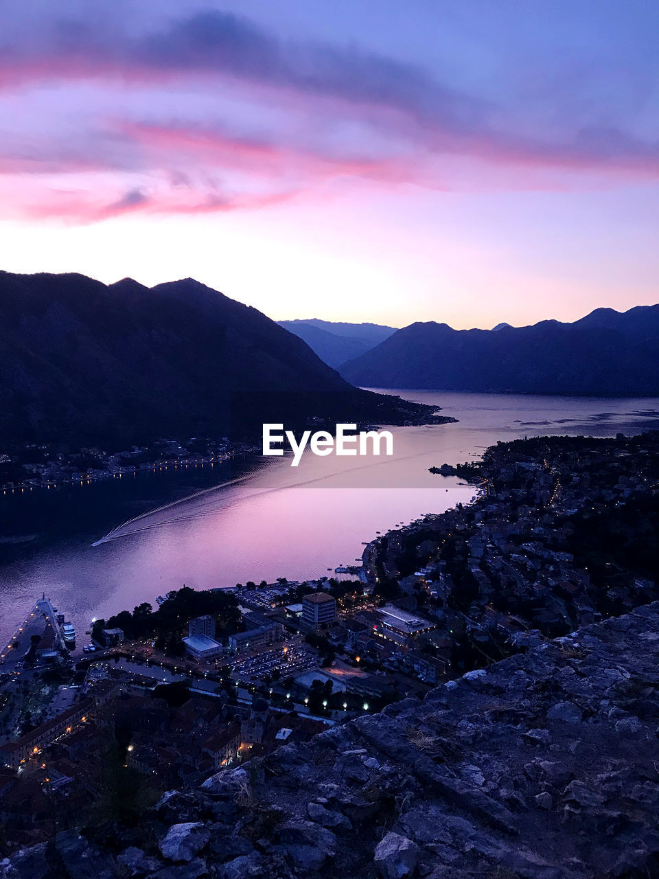 Scenic view of lake against sky at sunset