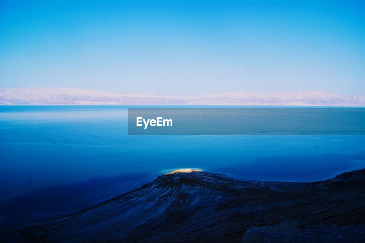 Scenic view of sea against blue sky