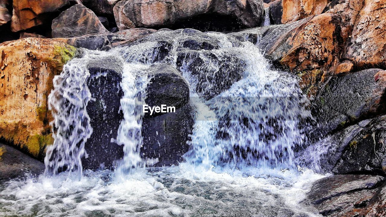 WATER SPLASHING ON ROCKS